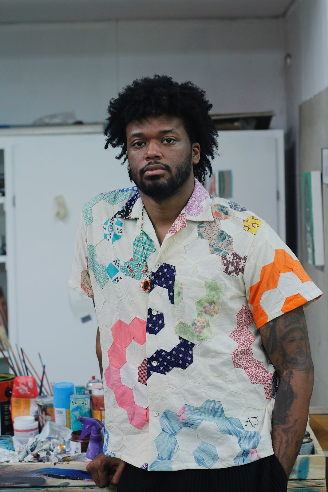 AJ Girard standing in an art studio